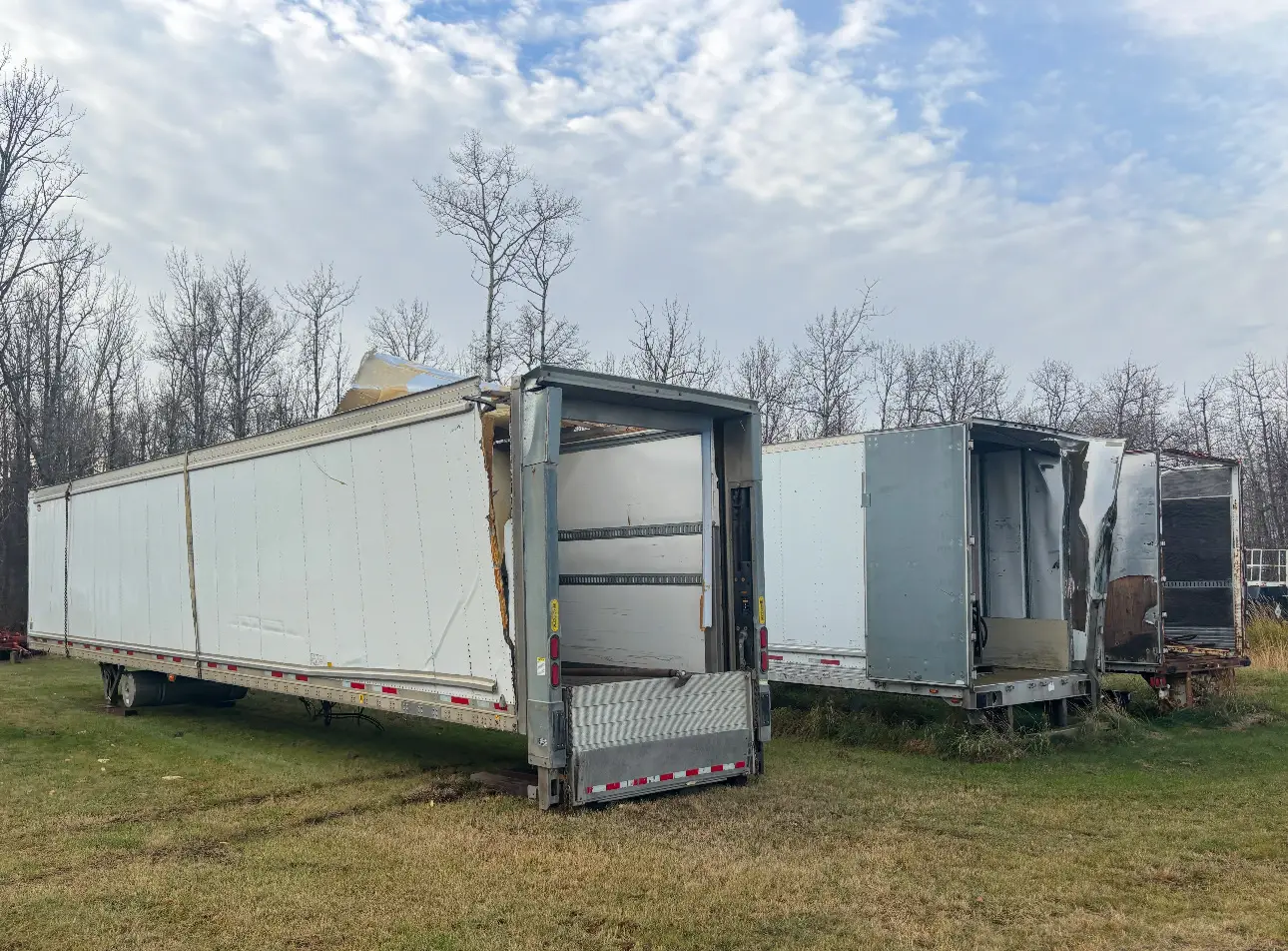 End-of-life trailers and flatbeds staged in yard for removal