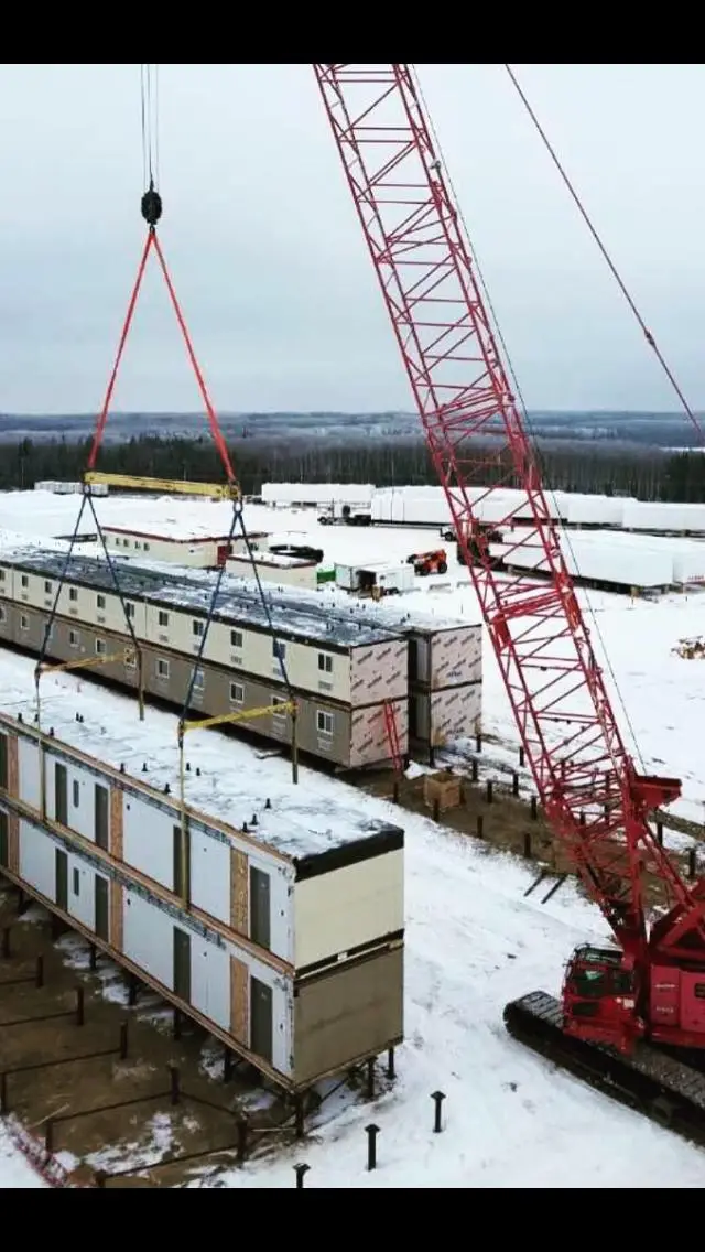 Workforce housing units being handled and staged for transport